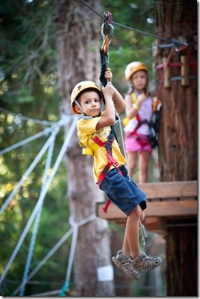6 year old Kids climbing trees in Dolomites, Italy.