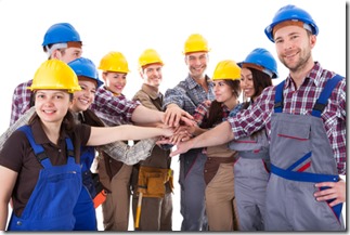 Diverse group of construction workers stacking hands